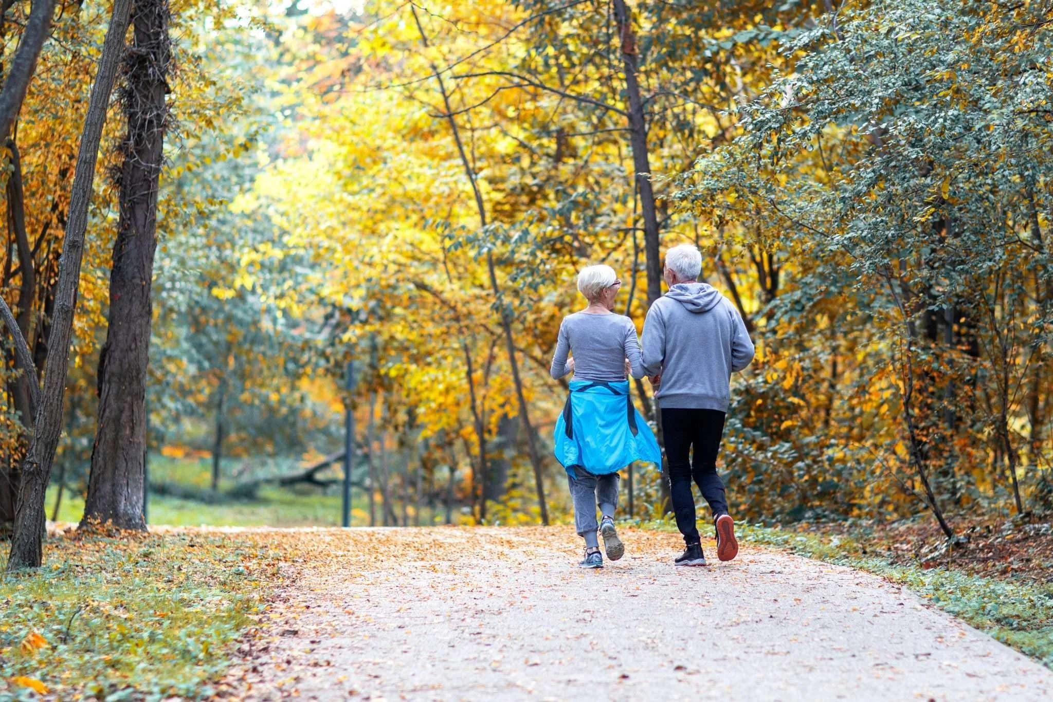 Mature couple man and woman jogging in the park