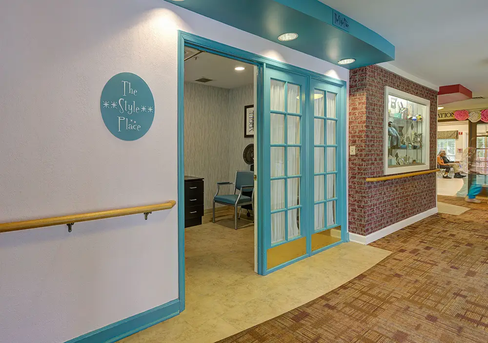 A hair salon with turquoise-framed glass doors and a sign reading "The Style Place" is open, showing chairs and salon equipment inside.