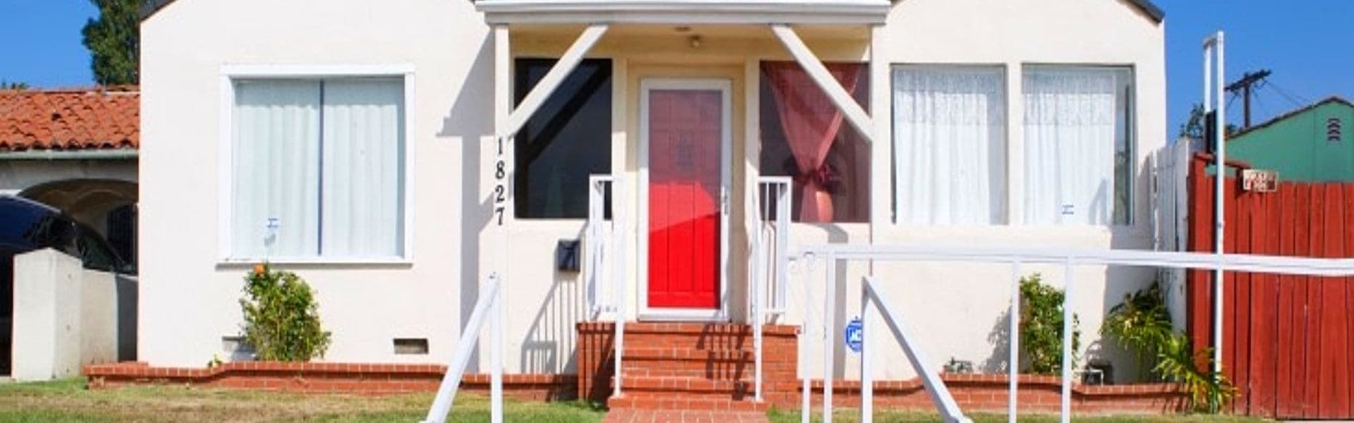 simple white house with a red door