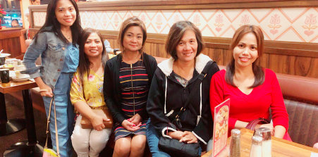 group of ladies smiling in front of a camera