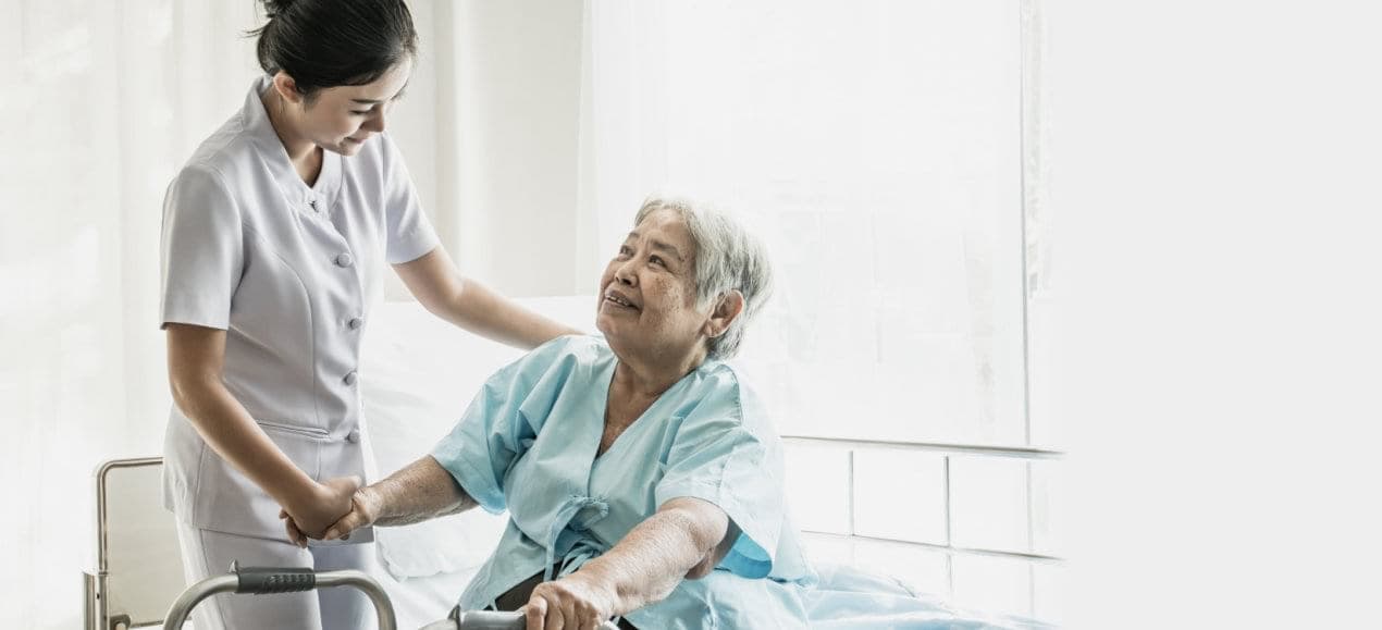 caregiver and elder woman smiling