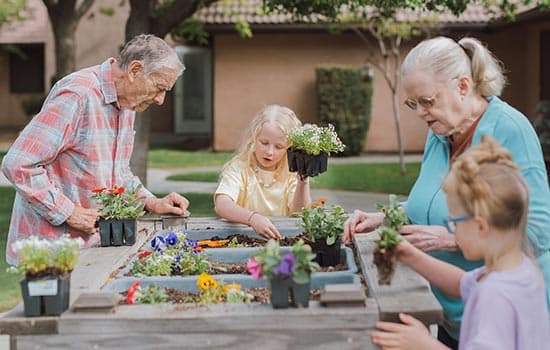 Seniors helping kids garden as part of memory care living in Fresno
