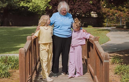 Senior woman walking with kids as part of memory care living in Fresno