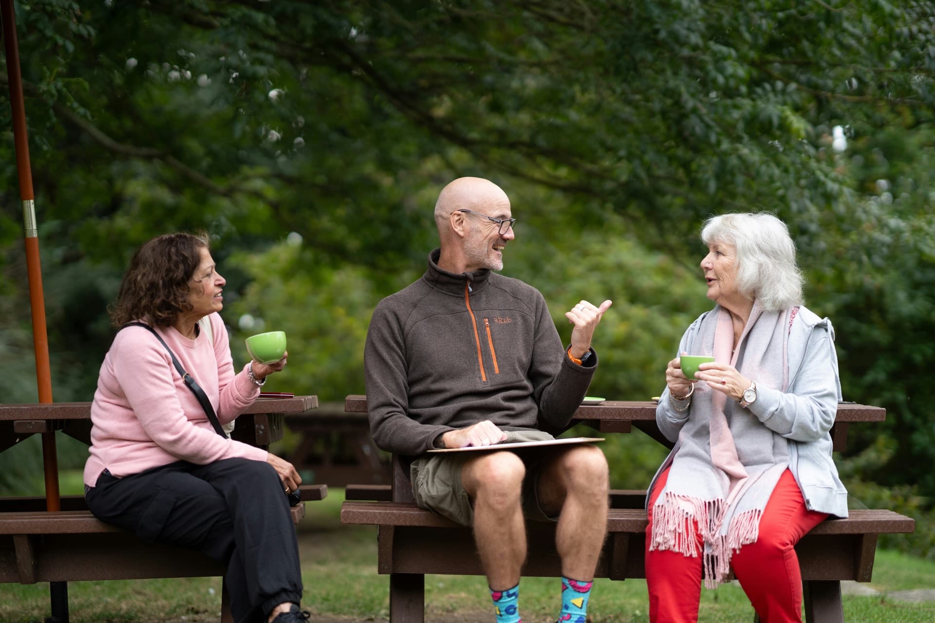 Seniors enjoying conversation outdoors in a community setting